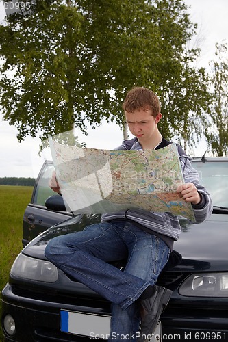 Image of Young driver with maps