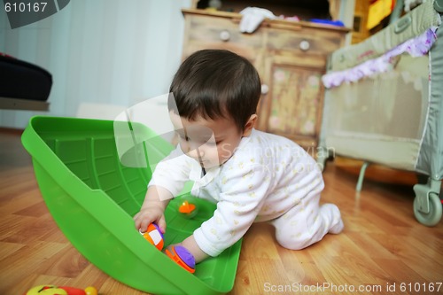 Image of adorable baby plays on floor, soft focus