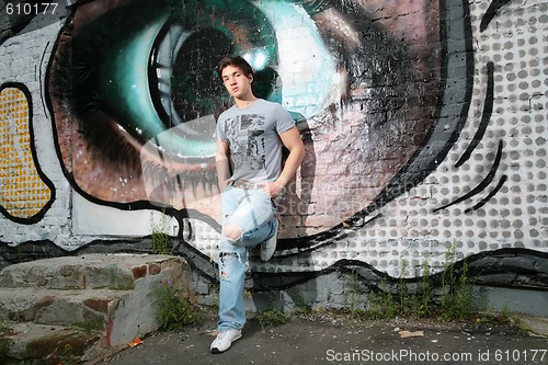 Image of lad near wall with graffiti