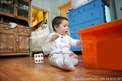 Image of baby plays in the room, soft focus