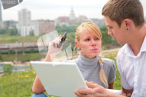 Image of man with laptop and girl