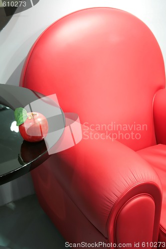 Image of red armchair and apple