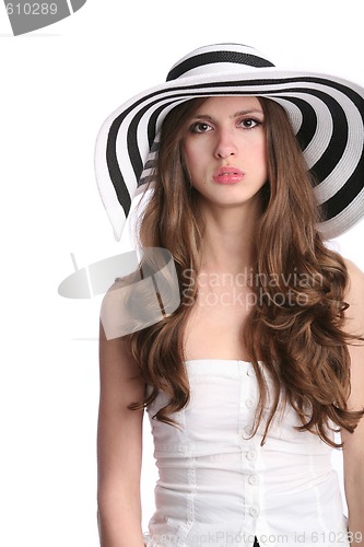 Image of beautiful sad girl in striped hat dreams on vacation