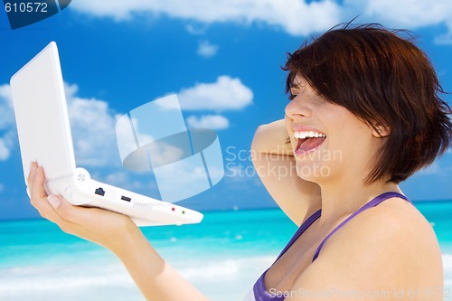 Image of woman with laptop computer on the beach