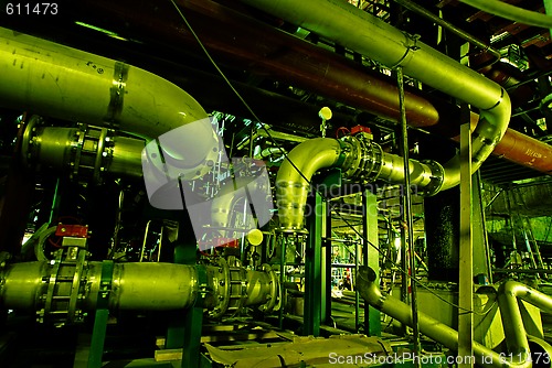 Image of Pipes, tubes, machinery and steam turbine at a power plant