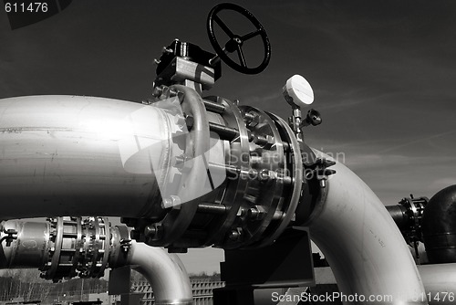 Image of industrial pipelines on pipe-bridge against blue sky b&w 