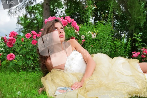 Image of princess lying under rosebushes