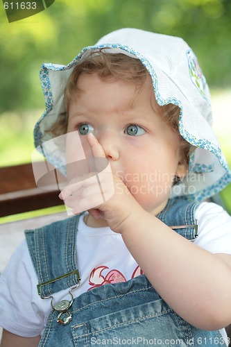 Image of small girl with finger near face
