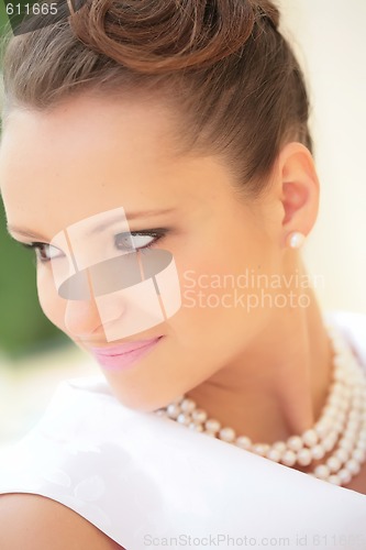 Image of smiling girl with pearl necklace