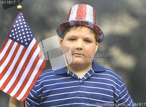 Image of Young boy holding US FLag