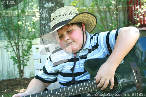 Image of Young boy playing guitar