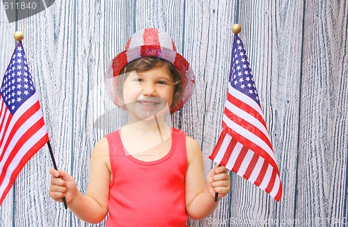 Image of Pretty little girl waving two US Flags