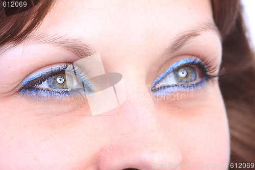 Image of beautiful woman`s open colorful eye