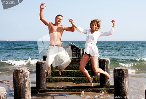 Image of Happy couple jumping