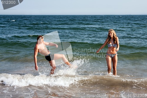 Image of Couple playing in ocean water