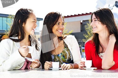 Image of Group of girlfriends having coffee