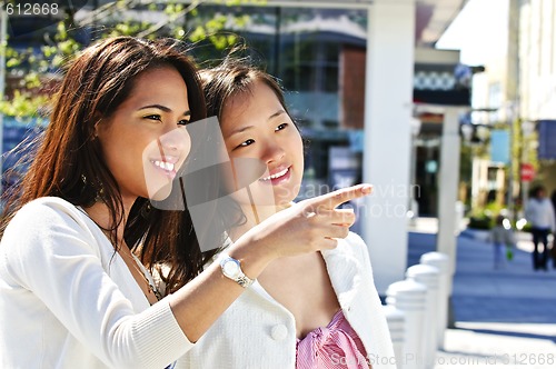 Image of Young friends pointing