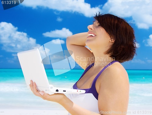 Image of woman with laptop computer on the beach