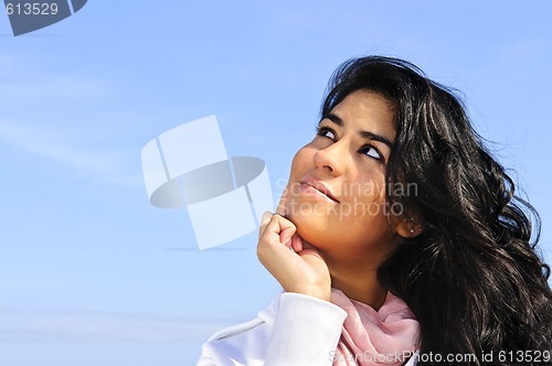 Image of Beautiful young woman looking up