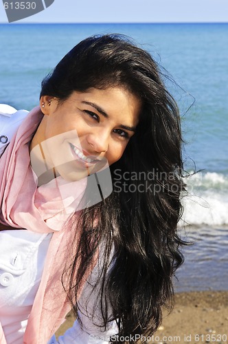 Image of Beautiful young woman at beach