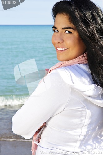 Image of Beautiful young woman at beach