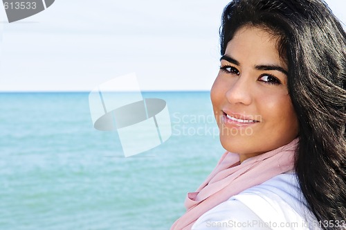 Image of Beautiful young woman at beach