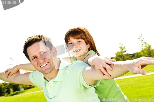 Image of Father and daughter piggyback