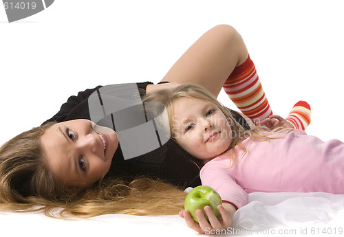 Image of daughter lies on mum on the floor