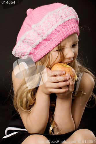 Image of little girl biting apple
