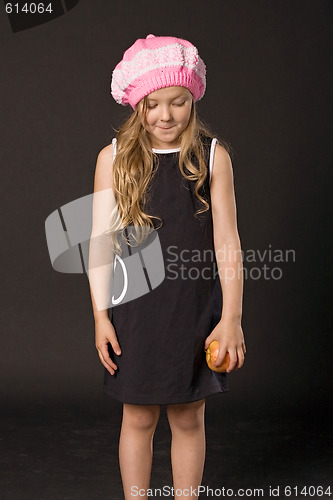 Image of sly little girl with apple