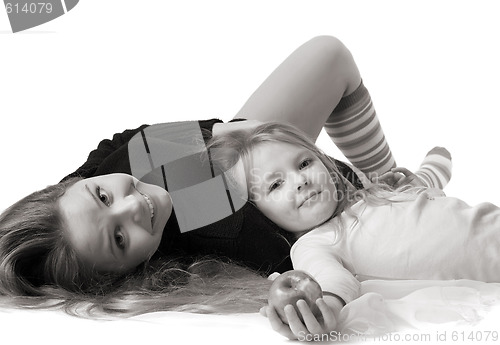 Image of daughter lies on mum on the floor