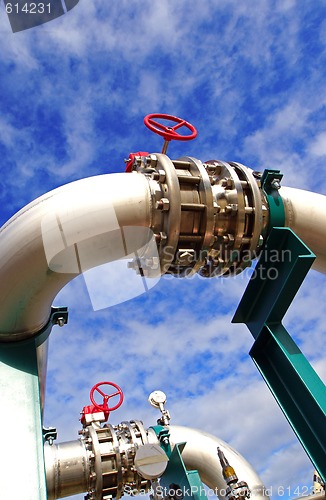 Image of Pipes, bolts, valves against blue sky