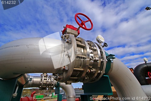 Image of Pipes, bolts, valves against blue sky