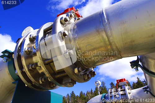 Image of Pipes, bolts, valves against blue sky