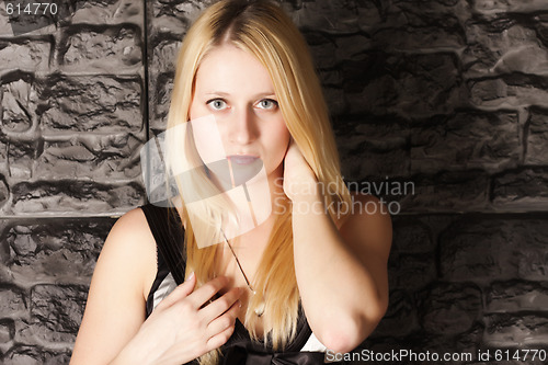 Image of Photo of blonde at wall