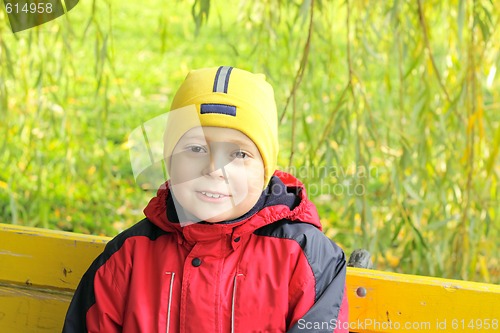 Image of Smiling boy on bench