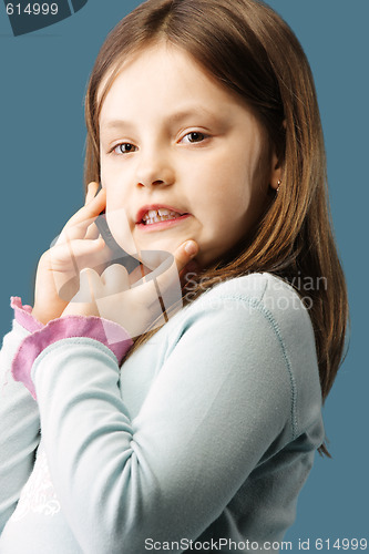 Image of Little girl with mobile at ear