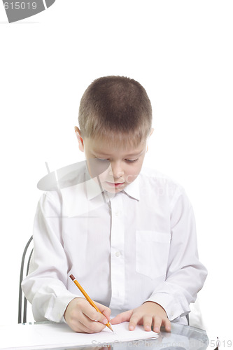 Image of Boy in white writing at table