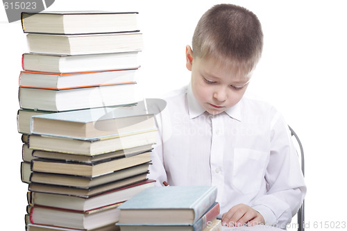 Image of Writing at table in books surrounding