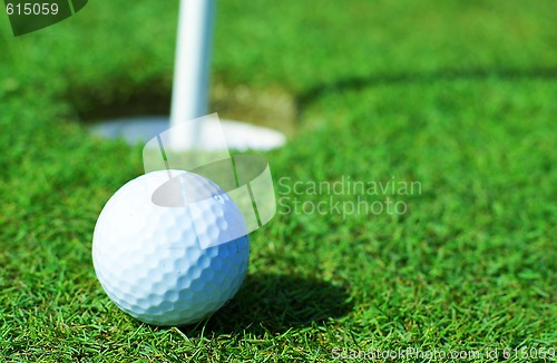 Image of Golfball in front of the hole