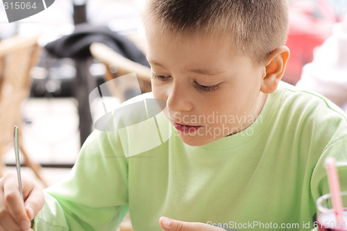 Image of Boy in outdoor cafe