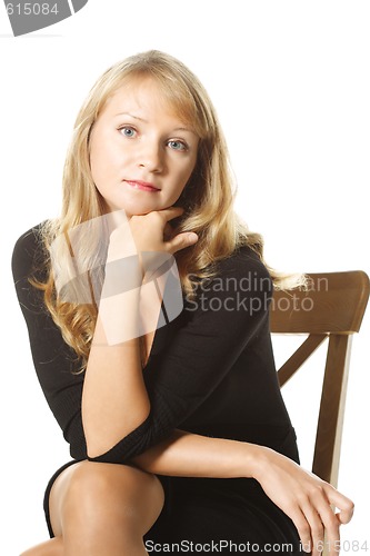 Image of Young woman in black sitting