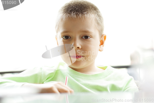 Image of Boy at table in counterlight