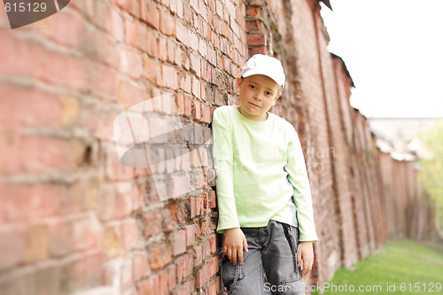 Image of Boy at old brick wall