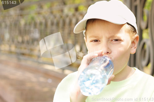 Image of Boy drinking water from bottle