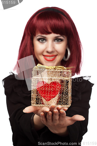 Image of Happy girl smiling with heart packed in a golden gift box