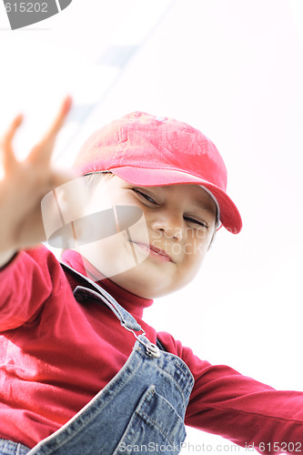 Image of Cheerful boy narrowing eyes