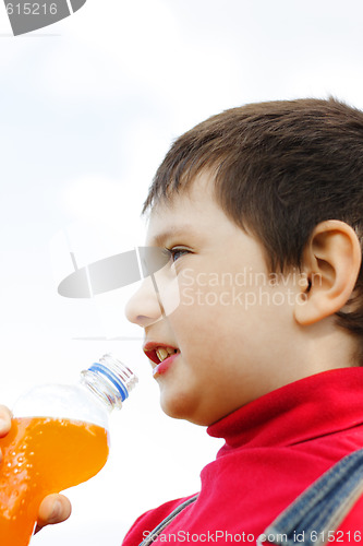 Image of Little boy with orange drink