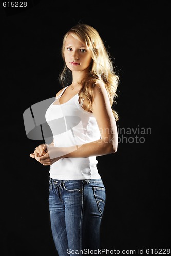 Image of Young woman in jeans sideview