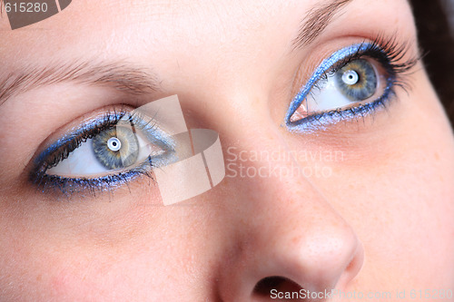 Image of beautiful woman`s open colorful eye